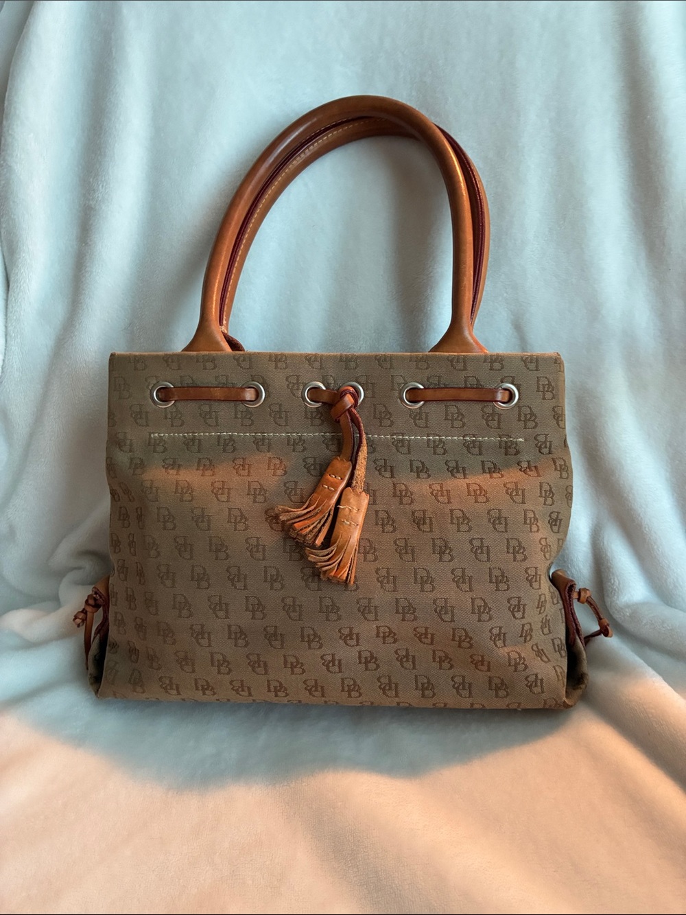 Dooney & Bourke 
Brown Monogram Handbag with Tassel Accent